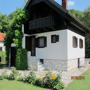 The chalet surrounded by flowers and the garden